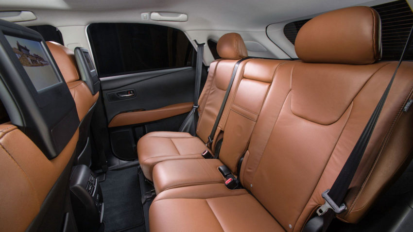 A car with brown leather seats and the back seat in the passenger compartment.