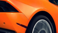 A close up of the side of an orange car