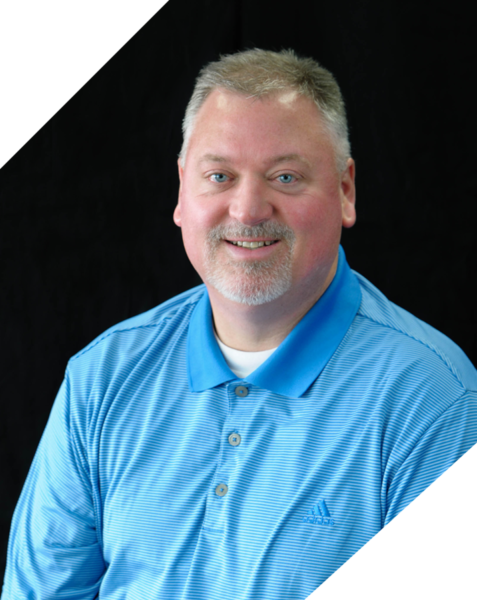 A man in blue shirt smiling for the camera.