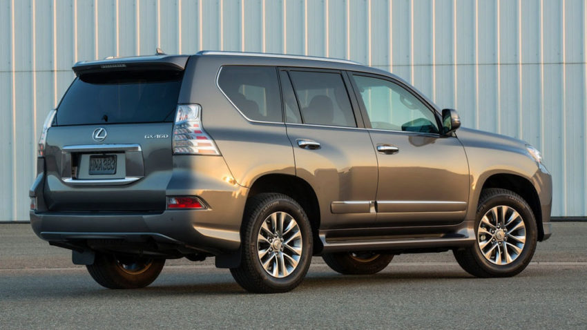 A silver suv parked in front of a building.