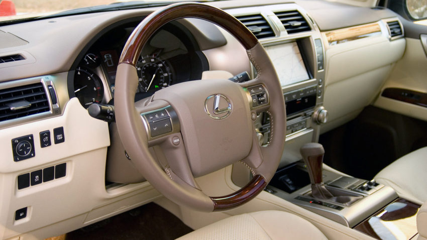 A car 's steering wheel and dashboard are shown.