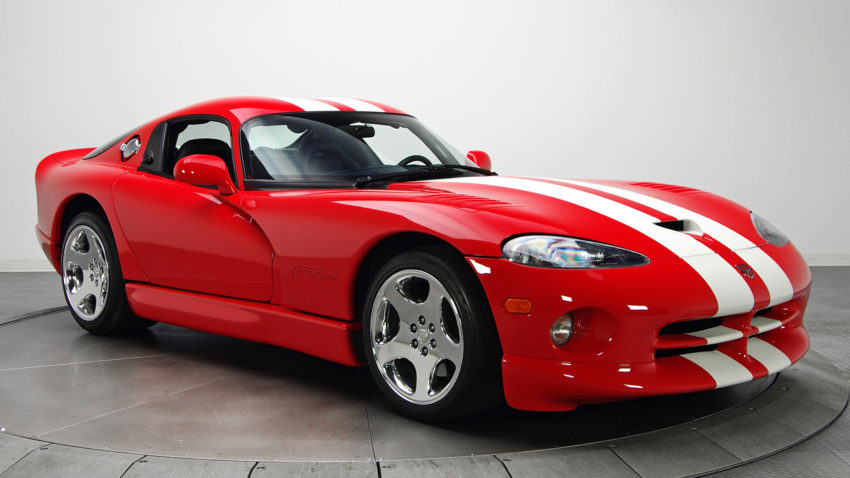 A red sports car with white stripes on the hood.