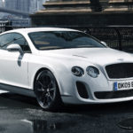 A white bentley continental gt is parked on the street.