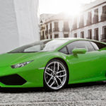 A green lamborghini parked on the side of a street.