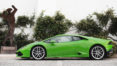 A green sports car parked on the side of a road.