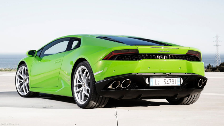 A green sports car is parked on the street.