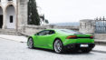 A green sports car parked on the side of a road.