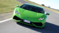 A green lamborghini driving down the road.