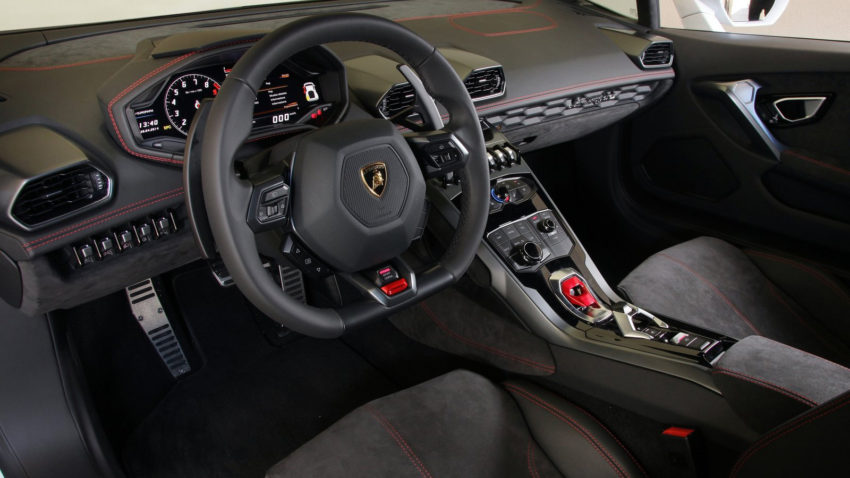 A car 's steering wheel and dashboard are shown.