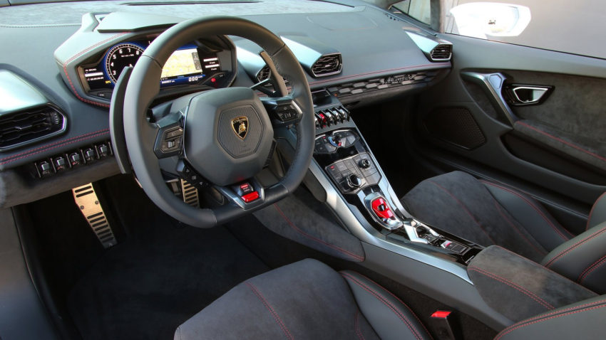 A car with many different controls and some grey seats