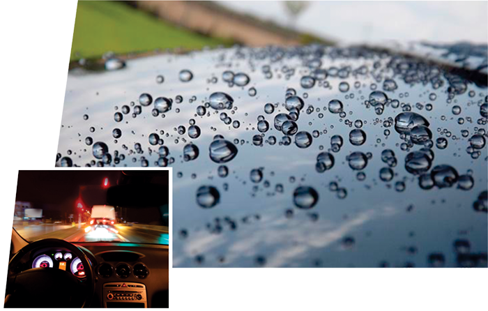 A car windshield with water droplets on it.